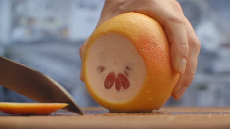 Cut-grapefruit-on-a-wooden-board-closeup.-shred.